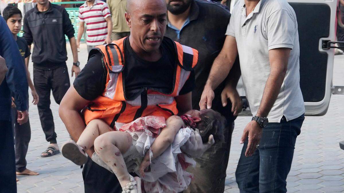 Palestinians wounded in the Israeli bombardment of the Gaza Strip are brought to a treatment room of al Aqsa Hospital in Deir al Balah on Tuesday, Oct. 31, 2023.