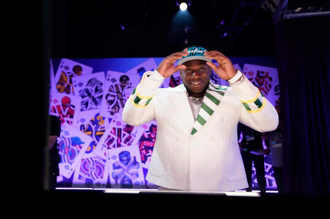 North Carolina State offensive tackle Ikem Ekwonu puts on a hat after being picked by the Carolina Panthers with the sixth pick of the NFL football draft Thursday, April 28, 2022, in Las Vegas.