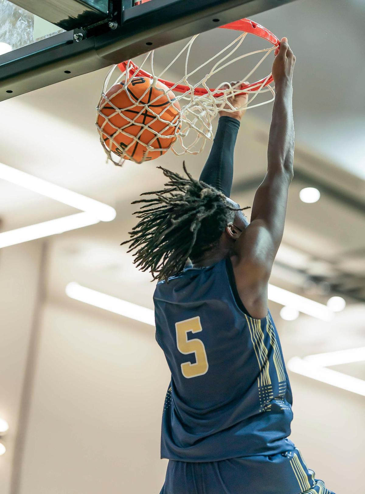 Hickory Grove’s Chas Stinson (5) gets the reverse dunk during late 1st half action at the Phenom Holiday Classic Wednesday December 23, 2020.