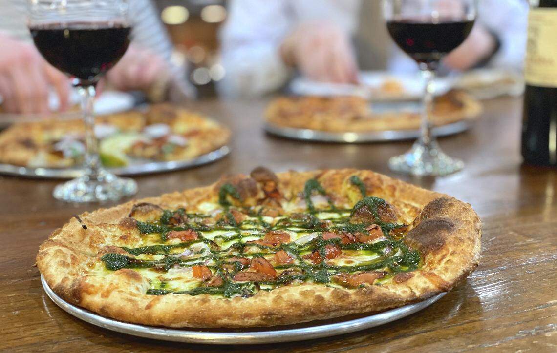 The pesto pizza at Pure Pizza’s 7th Street Market location has mozzarella, tomatoes, onions, basil and pesto.