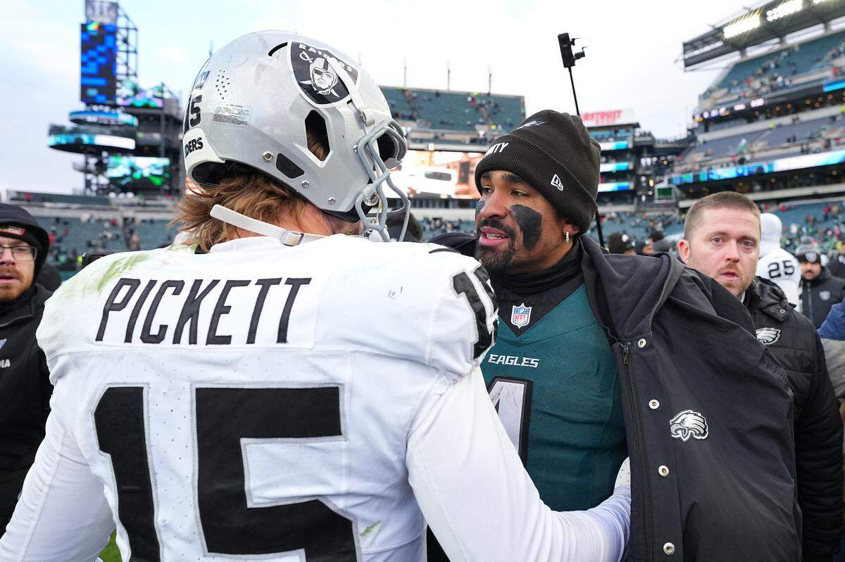 Then-Las Vegas Raiders quarterback Kenny Pickett and Philadelphia Eagles quarterback Jalen Hurts speak after a 2025 game at Lincoln Financial Field in Philadelphia.