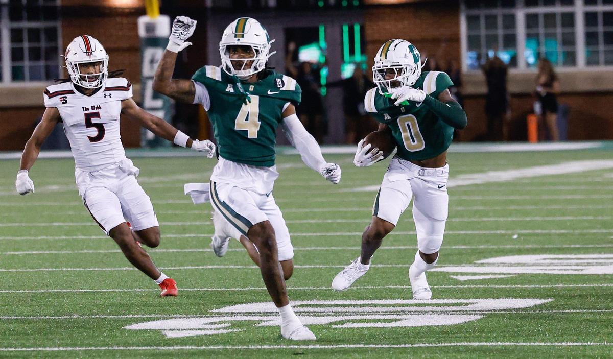 Charlotte Al-Ma’hi Ali, far right, runs the ball after intercepting a pass during the game against Gardner-Webb at Jerry Richardson Stadium in Charlotte, NC on Saturday, September 14, 2024. Charlotte came back in the fourth quarter to defeat Gardener-Webb, 27-26.