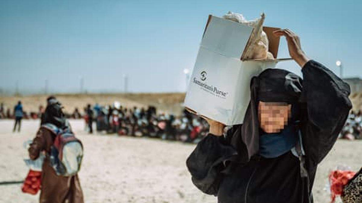 A resident of Gaza carries a box of relief supplies from Samaritan’s Purse after a relief flight by the Boone-based international Christian relief organization.