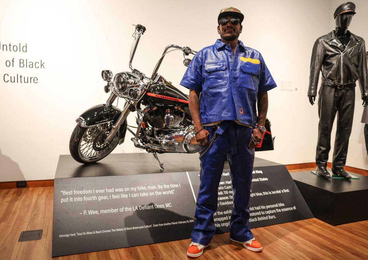 Photographer and social justice activist Alvin C. Jacobs Jr. with his personal Harley-Davidson motorcycle on display during the opening night of his “Black Behind Bars: The Untold Story of Black Bike Culture” exhibit. It’s at the Harvey B. Gantt Center for African-American Arts + Culture in uptown Charlotte.