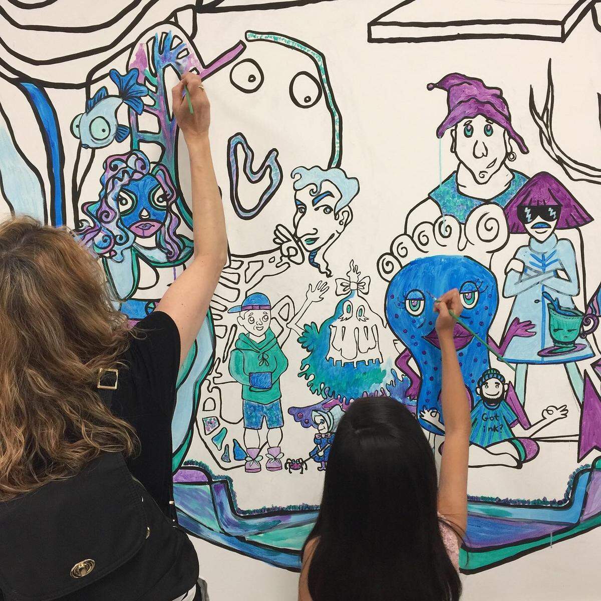 Two girls work on one of the murals at The Bridge, a new experimental workspace created by Arts+. It’s located near NoDa on Raleigh Street within walking distance of the Blue Line stop at Sugar Creek Road.. Arts+ is offering expanded arts programming there.