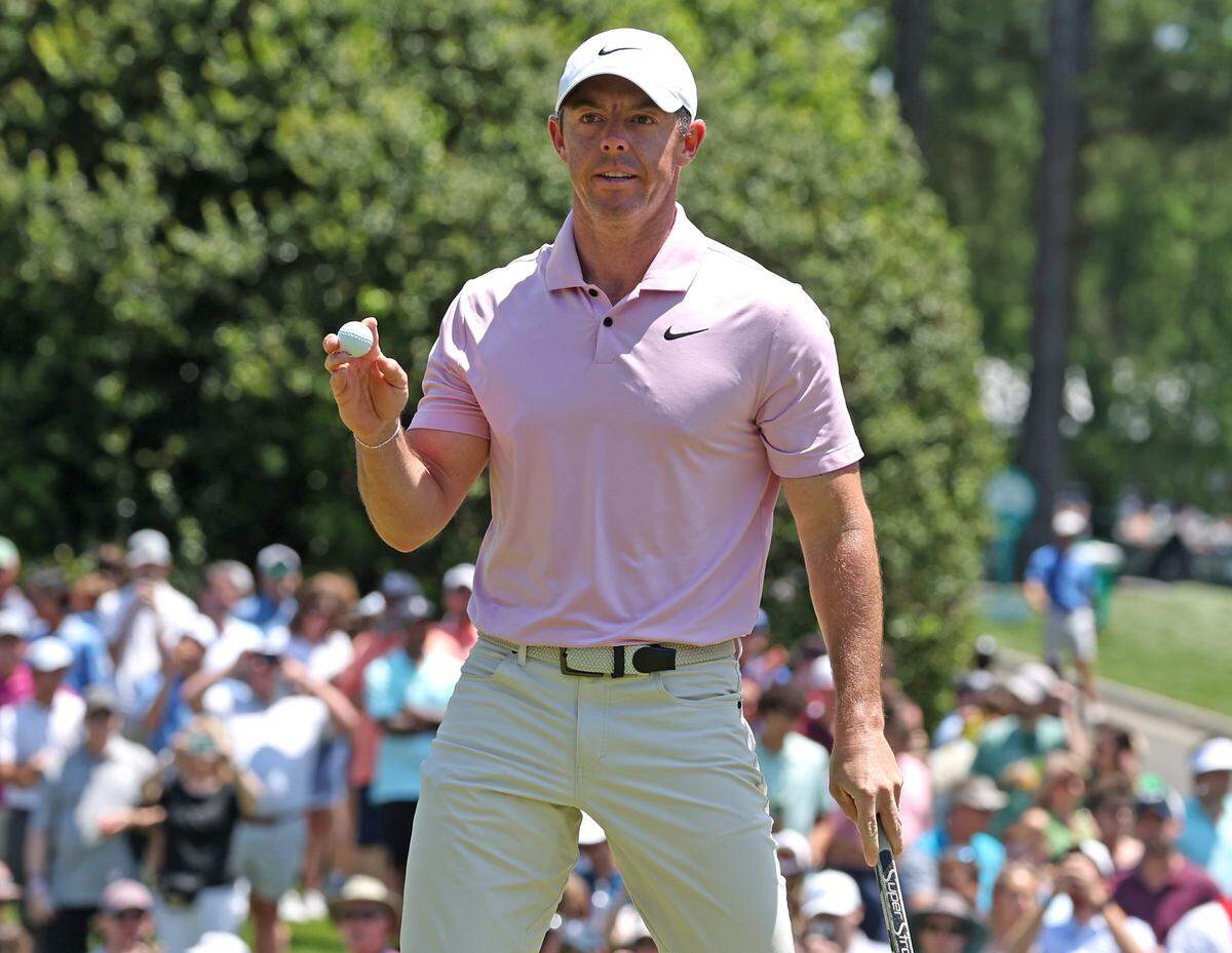 Rory McIlroy acknowledges the applause of the gallery after sinking a putt on the first green during the final round of the Wells Fargo Championship at Quail Hollow Club in Charlotte, NC on Sunday, May 12, 2024.