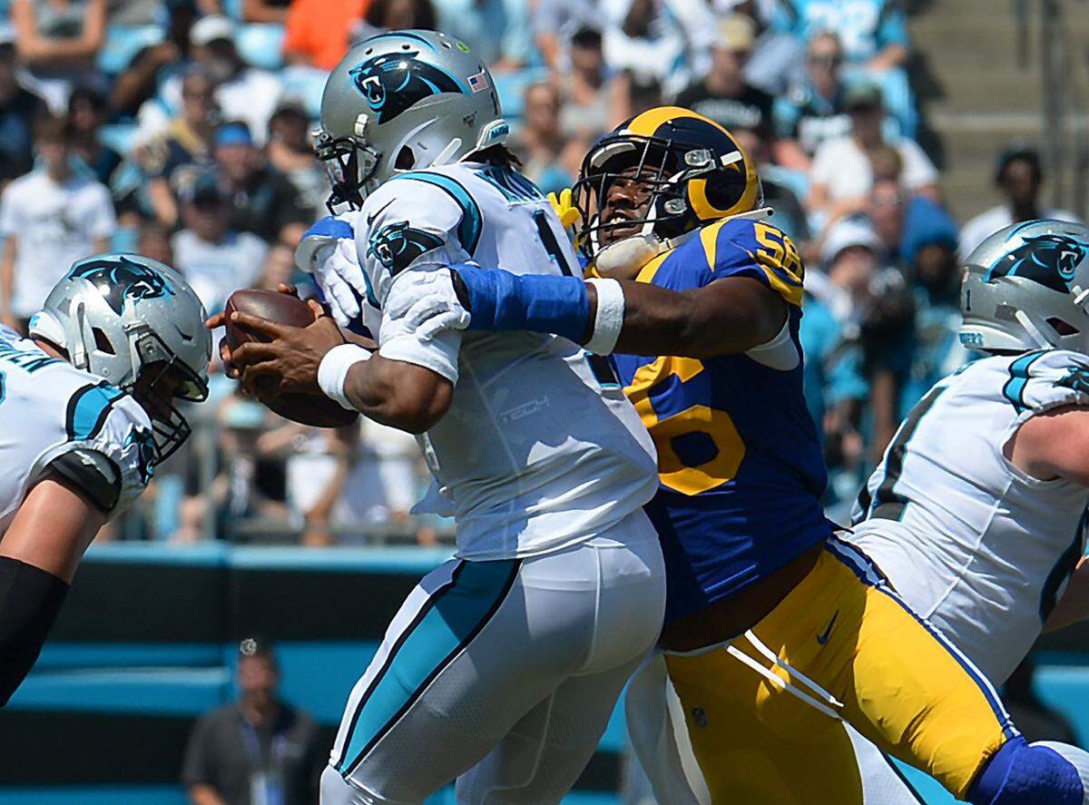 Carolina Panthers quarterback Cam Newton, left, is sacked by Los Angeles Rams outside linebacker Dante Fowler Jr. Newton was sacked three times Sunday and had two turnovers.