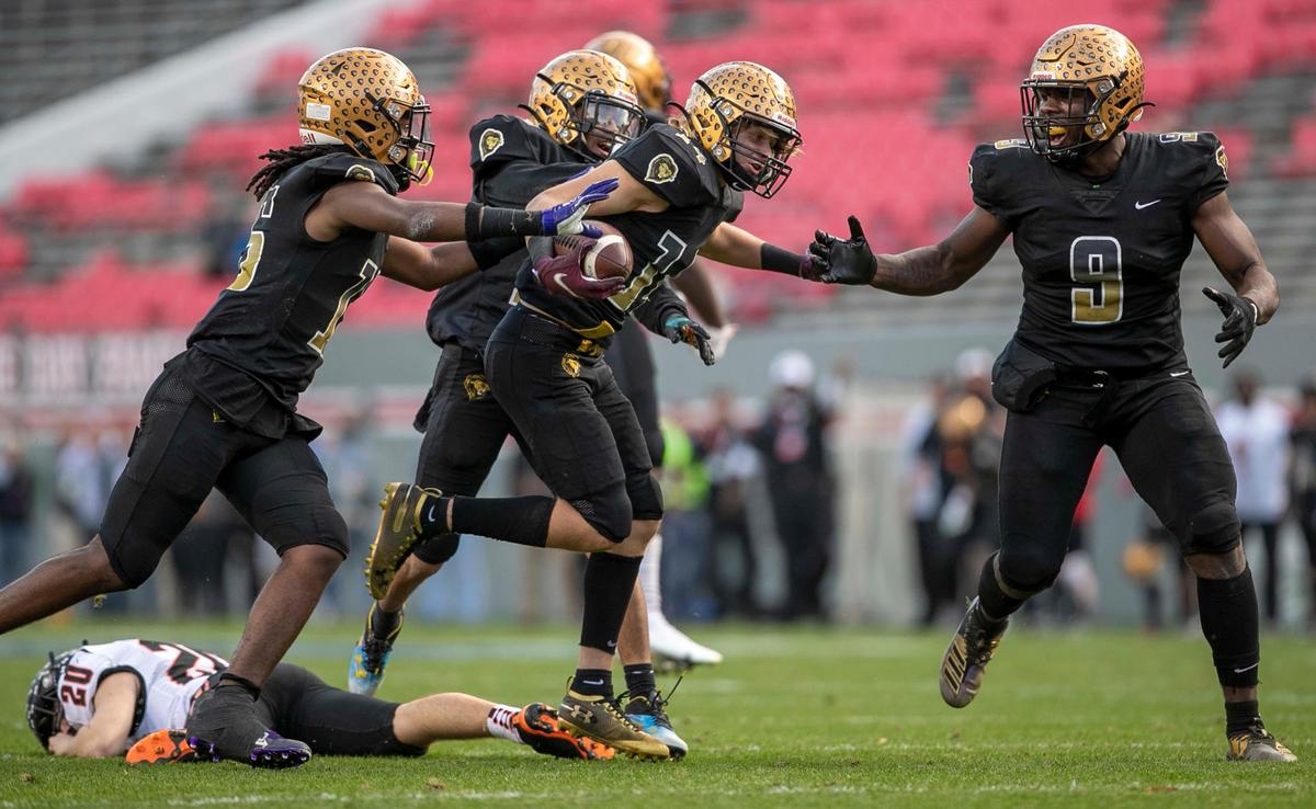 Shelby’s Drew Hollifield (14) celebrates after recovering a fumble by Wallace-Rose Hill punter Lon Teachey (20) in the second quarter during the NCHSAA 2-A championship game on Saturday, December 11, 2021 at Carter-Finley Stadium in Raleigh, N.C.