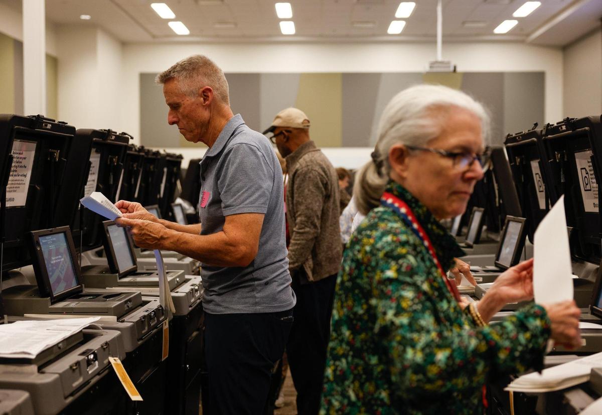 Volunteers feed ballots into ballot machines as Mecklenburg officials hold a recount in NC Supreme Court race, Tricia Cotham’s win over Nicole Sidman, and Woodson Bradley’s win over Stacie McGinn, at Valerie C. Woodard Community Resource Center in Charlotte, NC on Thursday, November 21, 2024.