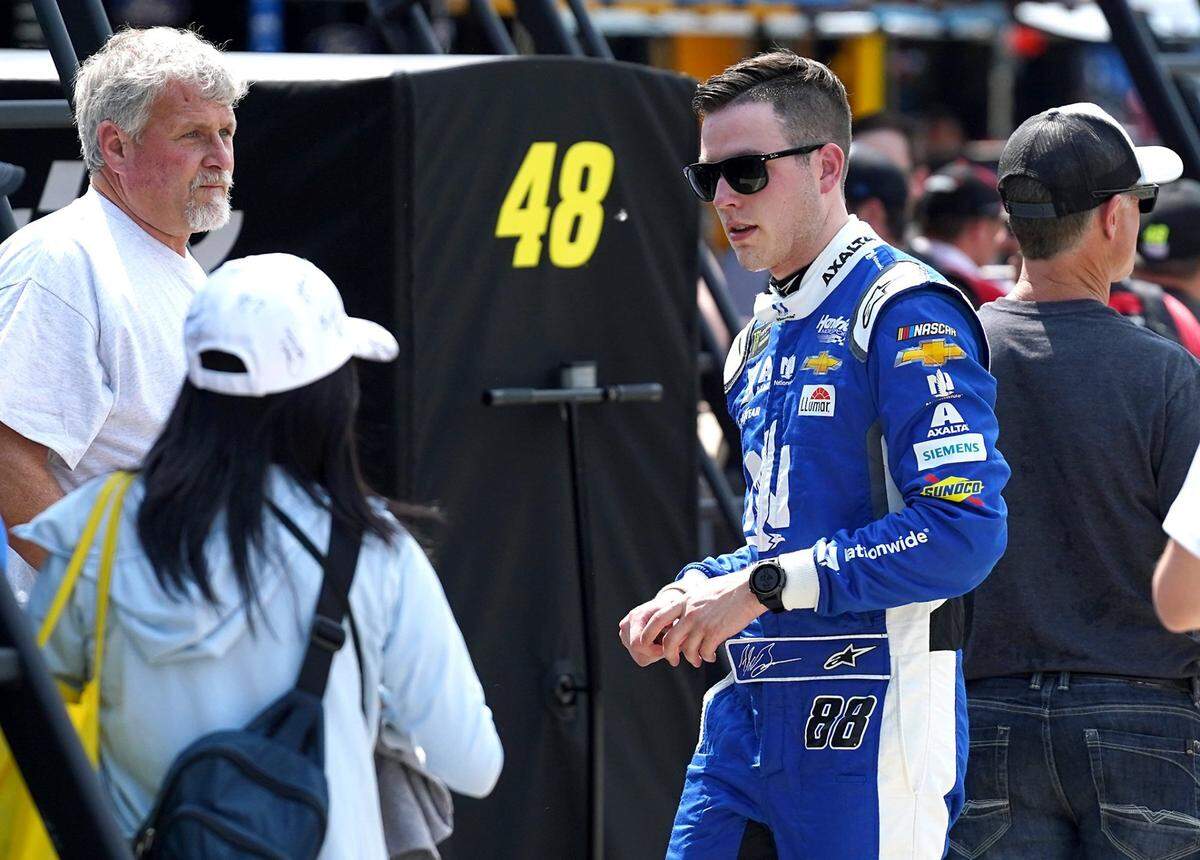 NASCAR driver Alex Bowman, right, walks back to his hauler following practice at Charlotte Motor Speedway on Thursday, May 23, 2019.