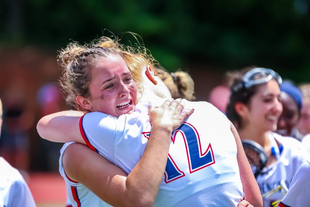 Providence Day lacrosse players celebrate in a heartfelt embrace moments after winning the state championship at Providence Day high school in Charlotte North Carolina on May 17, 2025