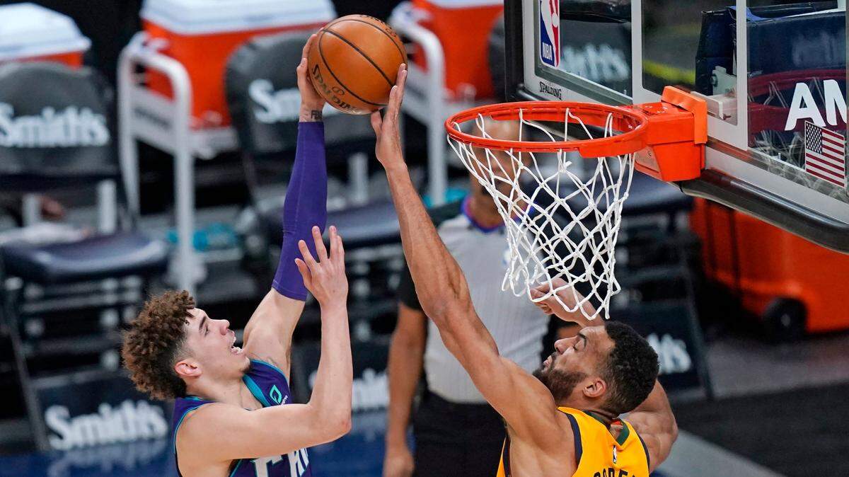 Charlotte Hornets guard LaMelo Ball (2) feels the presence of Utah Jazz center Rudy Gobert (27) in an NBA game. If the Hornets can trade for Gobert, the two could be teammates.