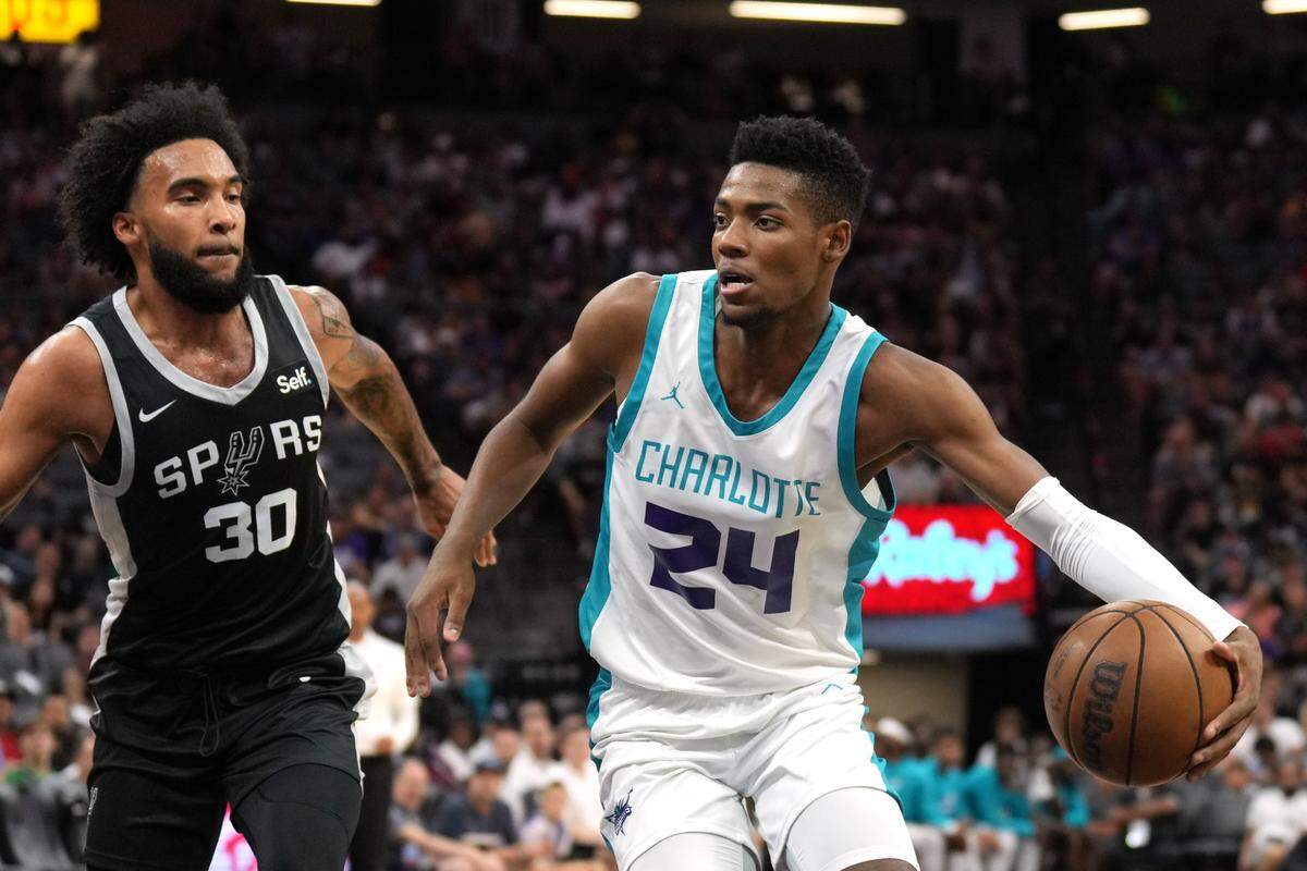 Charlotte Hornets forward Brandon Miller (24) dribbles against San Antonio Spurs forward Julian Champagnie (30) during the second quarter at Golden 1 Center.