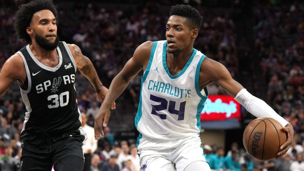 Charlotte Hornets forward Brandon Miller (24) dribbles against San Antonio Spurs forward Julian Champagnie (30) during the second quarter at Golden 1 Center.