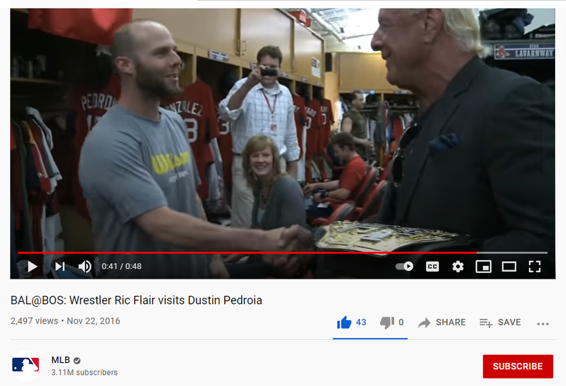 WWE icon Ric Flair shocked retired Boston Red Sox second baseman Dustin Pedroia by appearing in the Red Sox locker room at Fenway Park on Friday night, June 25, 2021. Flair is Pedroia’s idol.. Pedroia was about to be honored on the field for his 17-year career.. Flair gave him a gold world championship wrestling belt.