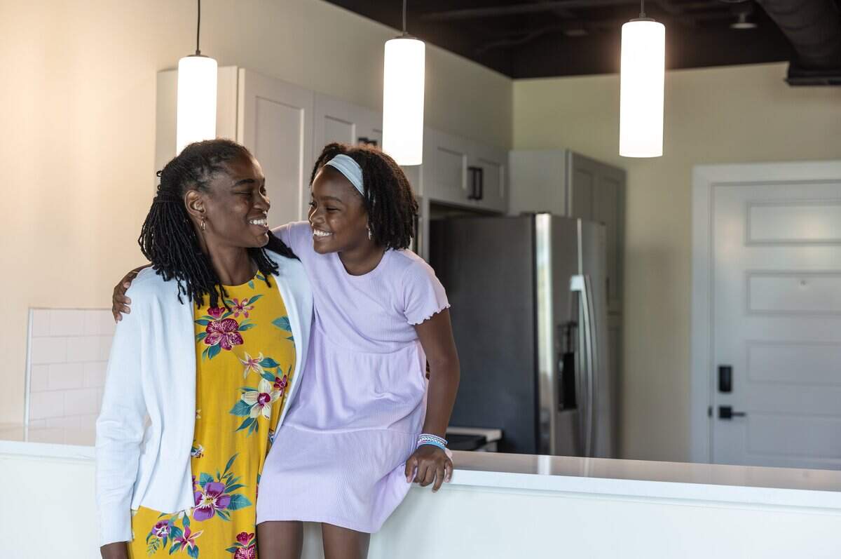 Tyanna Vandyke and her daughter, Titiana, 8, pose for a portrait in their new apartment during WeBuild Concord’s ribbon-cutting ceremony for The Sanctuary Apartments in Concord, N.C., on Tuesday, July 14, 2026.