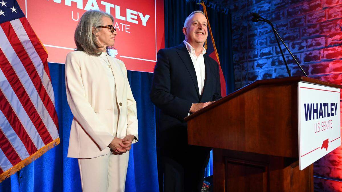 Suzanne Whatley, left, looks at her husband, Michael Whatley, right, as he prepares to deliver his victory speech on Tuesday, March 3, 2026 at Noble Smoke in Charlotte, NC. Whatley won the Republican Party Primary for U.S. Senate.