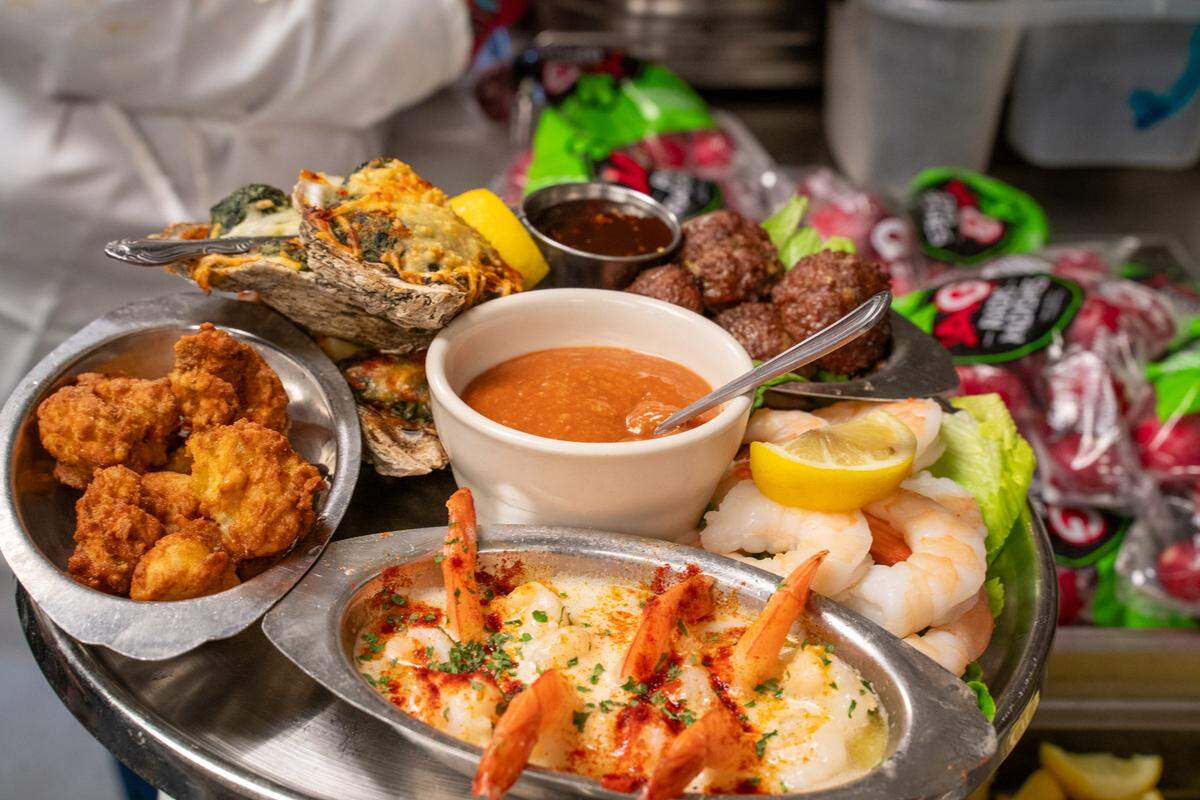 A variety of Beef ‘N Bottle appetizers including shrimp scampi, shrimp cocktail, house-made meatballs and oysters Rockefeller.