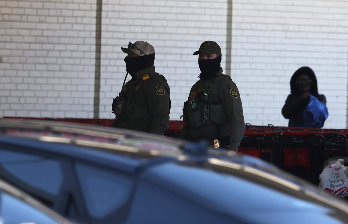U.S. Customs and Border Patrol agents at the Compare Foods on North Tryon Street in Charlotte on Nov. 17.