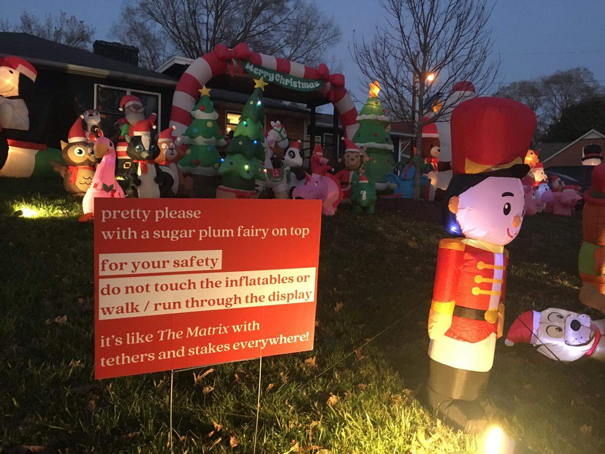 The Carroll family set up their record number of holiday inflatable decorations this year, 86, at their home on Wilhelmina Avenue in Plaza Midwood. A sign went up for safety a few years ago after a rowdy bachelorette party visited the house late one night.
