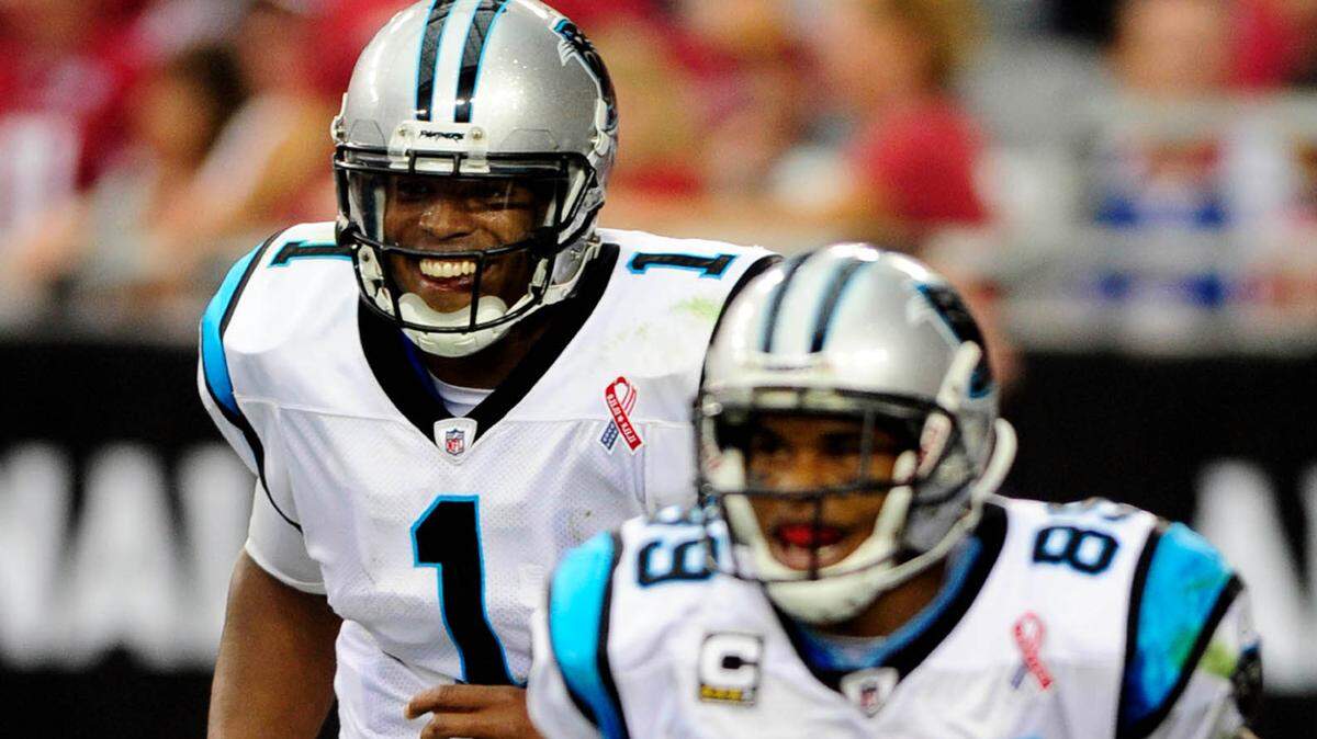 Carolina Panthers’ Cam Newton (1) smiles as he and Steve Smith (89) celebrate their second touchdown pass against the Arizona Cardinals on Sunday, September 11, 2011, at University of Phoenix Stadium. Arizona won, 28-21. Newton became the first rookie to throw for more than 400 yards in his NFL debut and threw TD passes to Smith of 75 and 26 yards. David T. Foster III-dtfoster@charlotteobserver.com