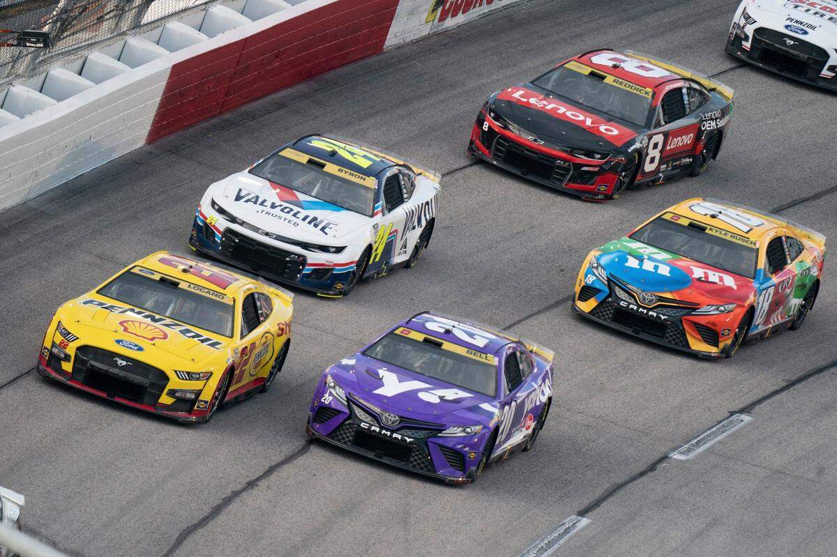 Christoper Bell (21), Joey Lagano (22), William Byron (24), Kyle Busch (18) and Tyler Reddick (8) compete in the NASCAR Southern 500 auto race, Sunday, Sept. 4, 2022, in Darlington, S.C. (AP Photo/Sean Rayford)