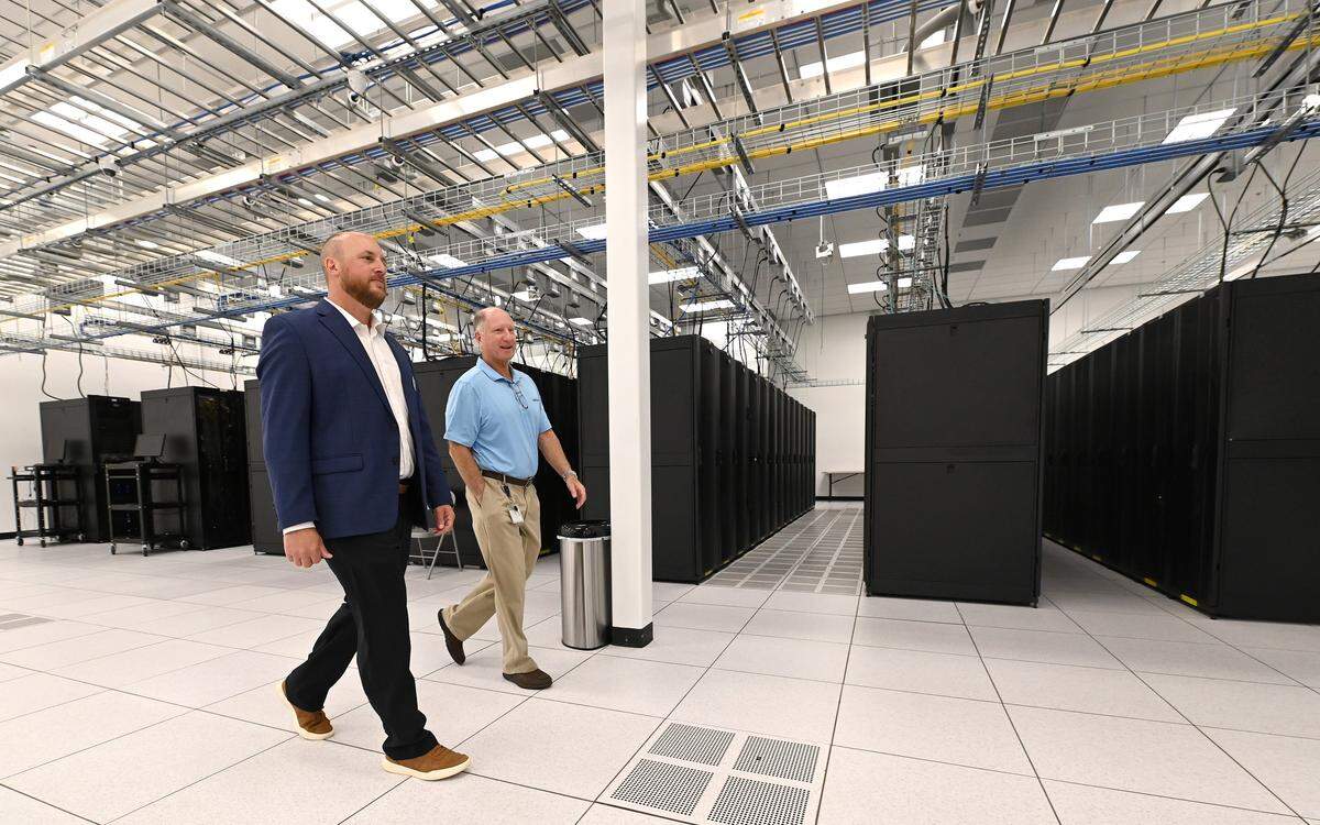 Chris Allgauer, Segra's senior director data centers, left and data center manager Glenn Palehonki, right, exit the company's CLT 2 data center on Monday, October 27, 2025.