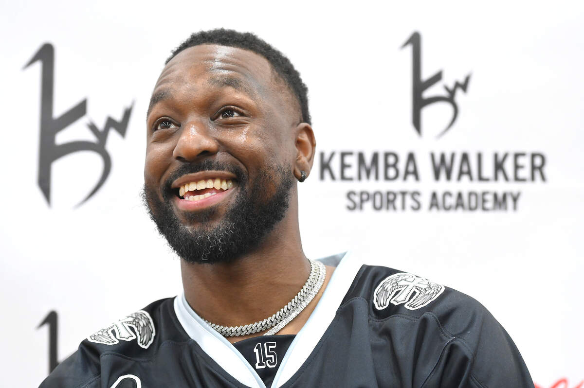 Former Charlotte Hornets guard Kemba Walker smiles as he answers questions about the Kemba Walker Sports Academy  at its grand opening Friday.