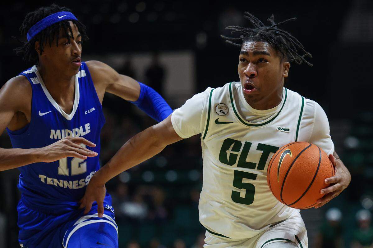 The Charlotte 49ers’ Isaiah Folkes, right, drives the ball past Middle Tennessee’s Teafale Lenard, Jr. during a game at Dale F. Halton Arena on Thursday, December 29, 2022.
