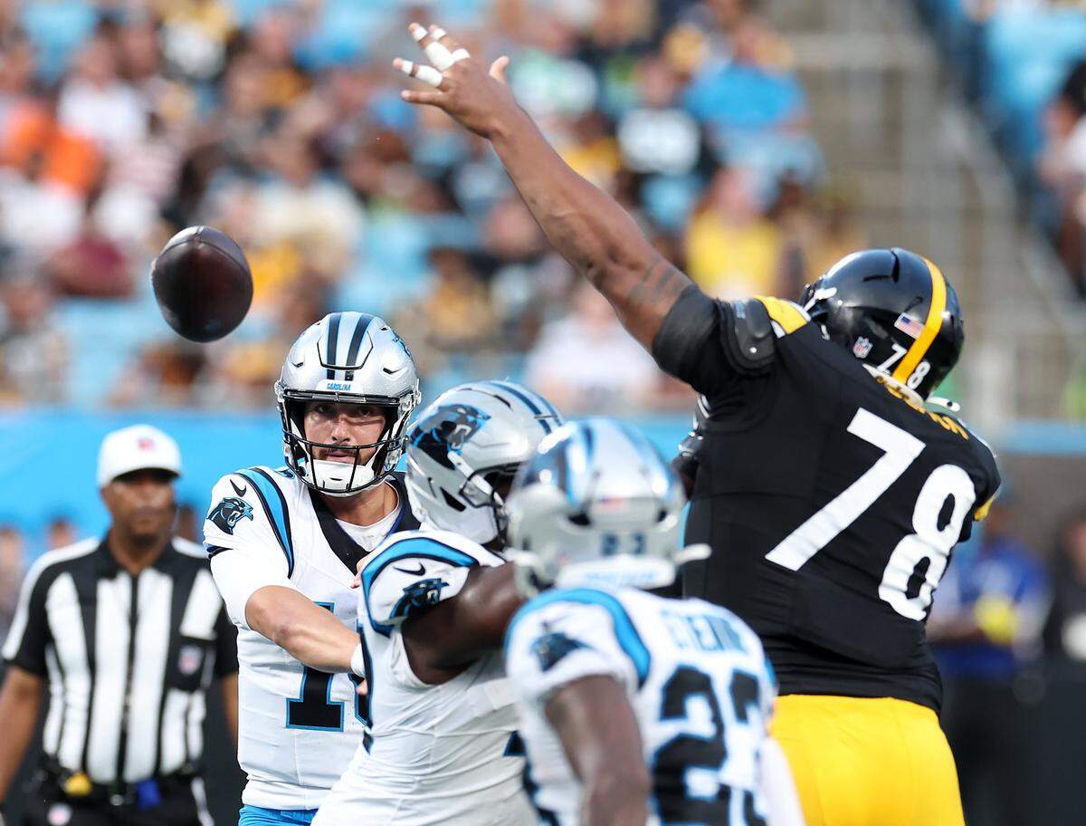 Carolina Panthers quarterback Jack Plummer, left, passes to a receiver during action against the Pittsburgh Steelers at Bank of America Stadium in Charlotte, NC on Thursday, August 21, 2025.