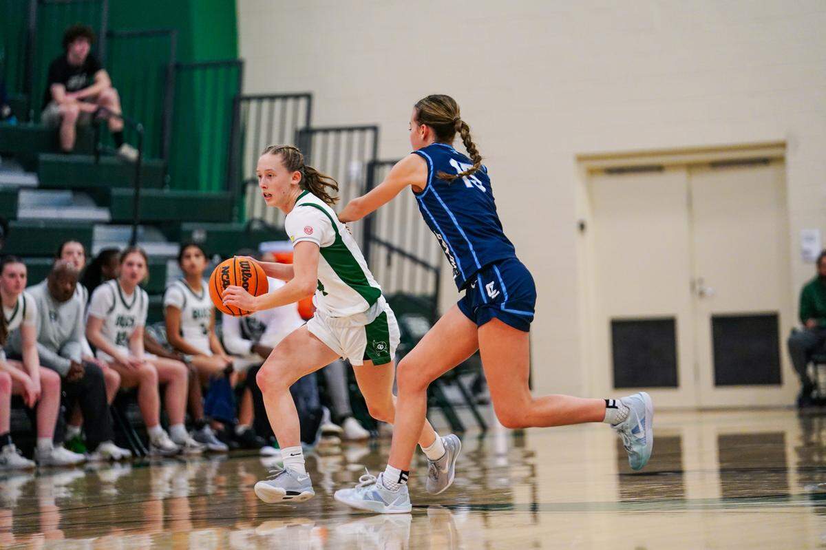 Charlotte Country Day’s Sam Vanderhave (left, with ball) was honored Thursday for scoring her 1,000th career point