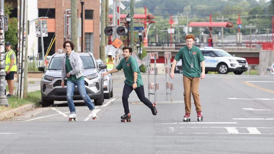 John Higgins, center, and Ben Marshall, right, of “Saturday Night Live”, along with a stunt double representing Martin Herlihy at left, film scenes from “Please Don’t Destroy” in NoDa on July 25.