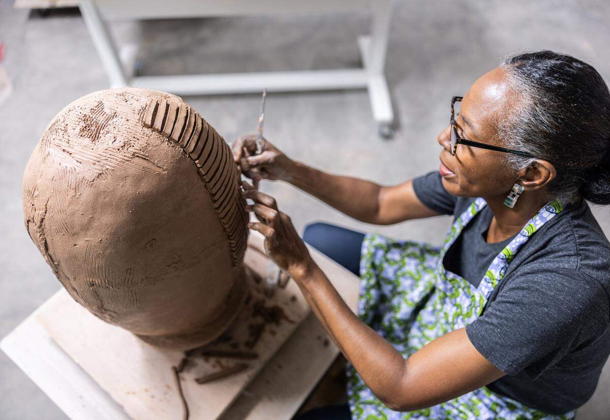 UNC Charlotte art professor Lydia Thompson works on an art project at her studio in Charlotte. She recently studied art and culture in Ghana with the help of an international travel grant. 