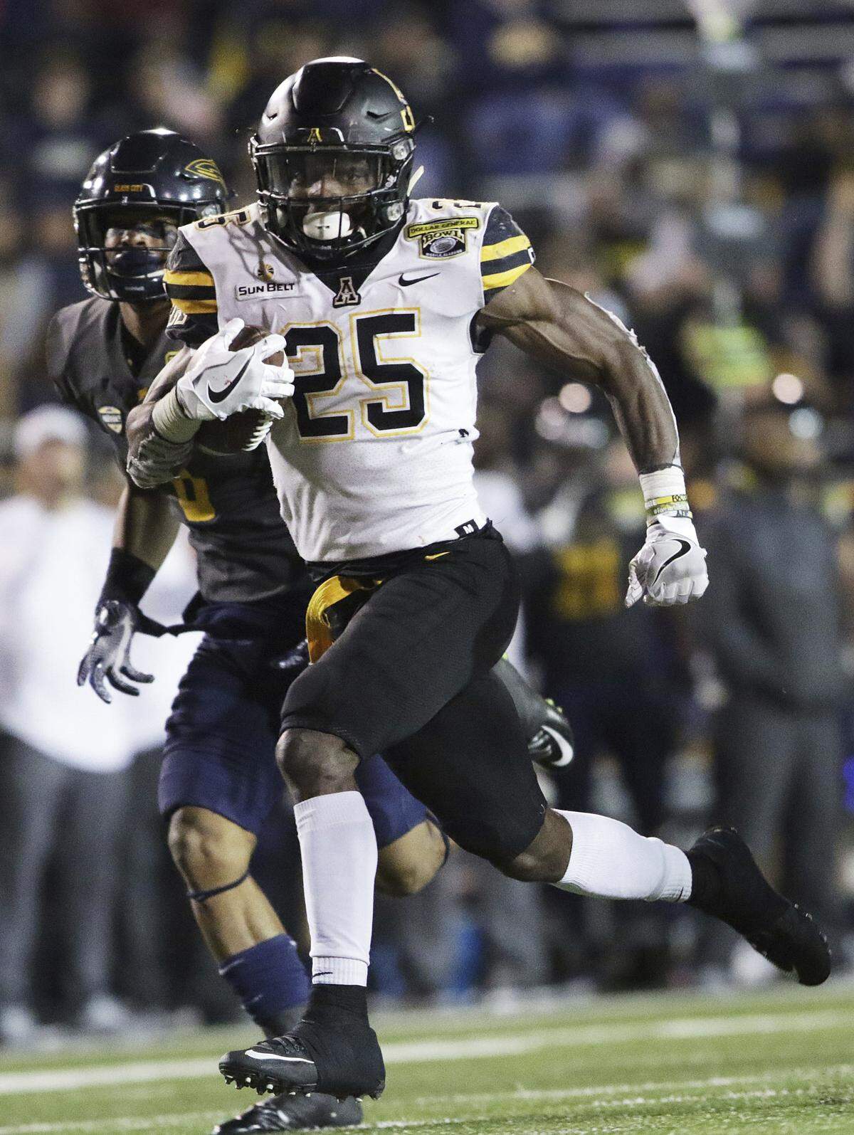 Appalachian State running back Jalin Moore (25) runs past Toledo cornerback Josh Teachey (8) to score a touchdown in the second half of the Dollar General Bowl NCAA college football game, Saturday, Dec. 23, 2017, in Mobile, Ala. (AP Photo/Dan Anderson)