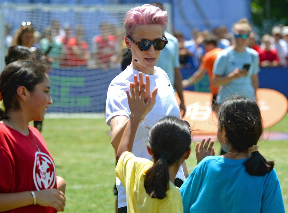 Megan Rapinoe, the Most Valuable Player of the Women’s World Cup, gives high fives to young soccer players during an event at the House of Soccer in Charlotte Saturday.