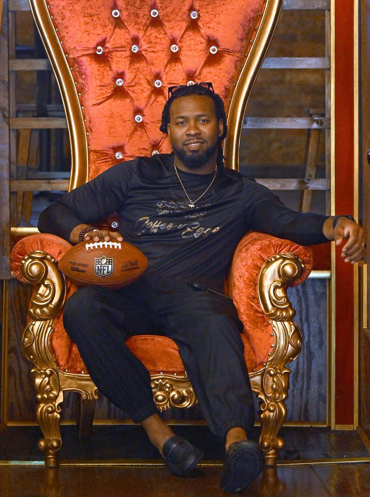 Former Carolina Panthers cornerback Josh Norman in April, seated on a throne at his restaurant in Atlanta.