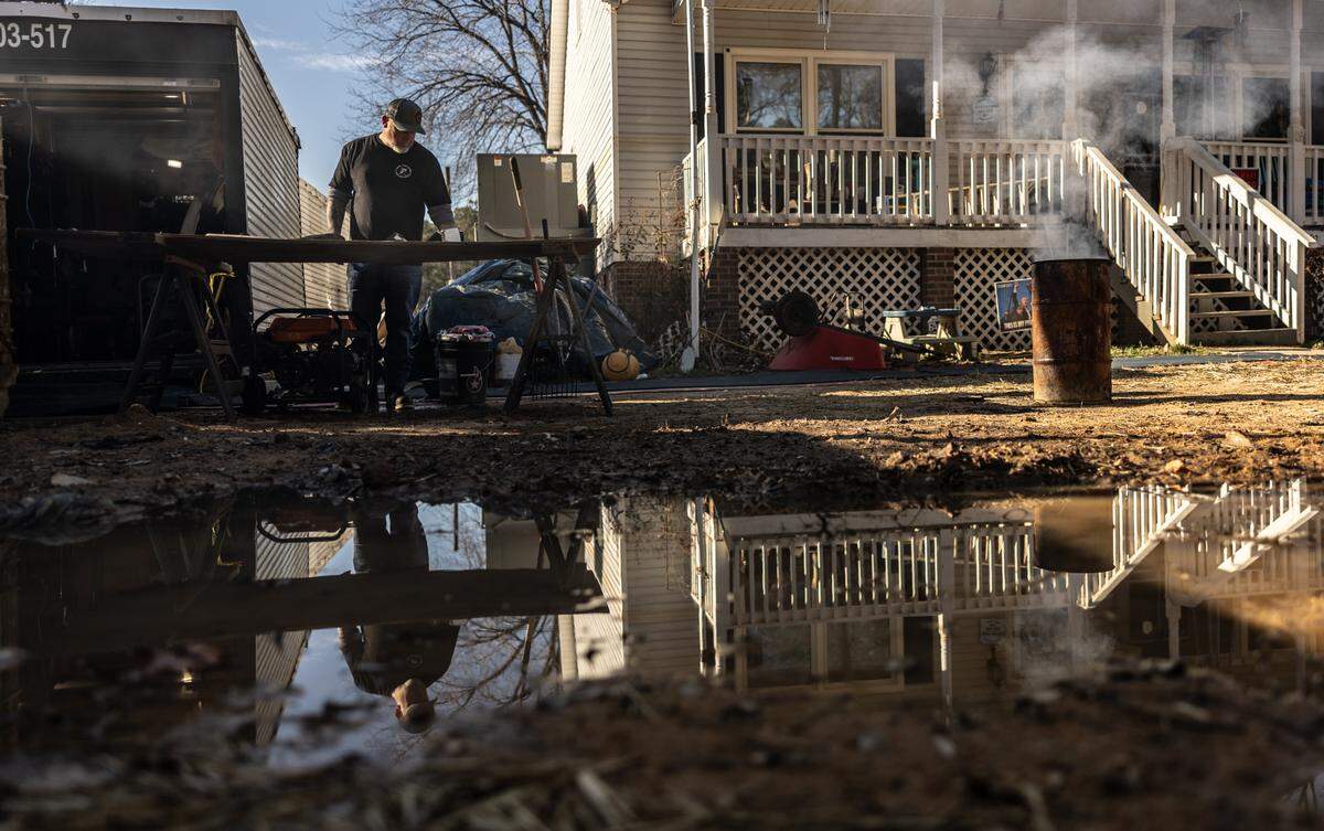 Says Lake Drive resident Donnie McGuire of the process of clearing trash and salvaging belongings in the wake of the September’s devastating flood: “It’s a LOT of f------ work.”