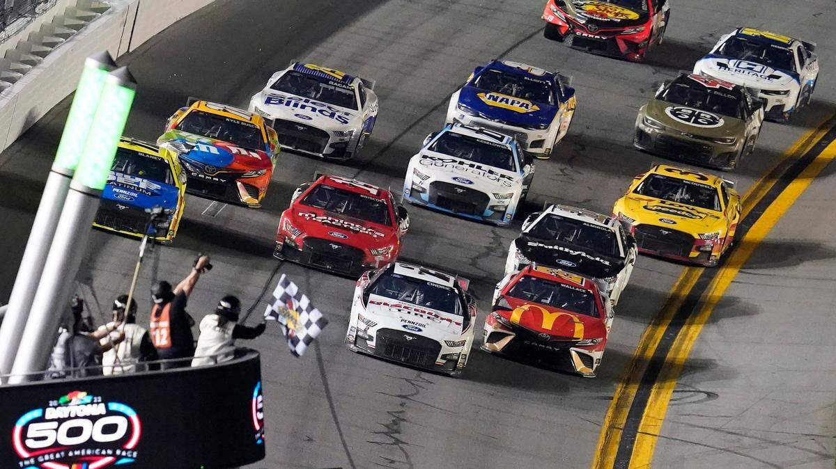 Austin Cindric (2) beats Bubba Wallace (23) to the checkered flag to win the NASCAR Daytona 500 auto race Sunday, Feb. 20, 2022, at Daytona International Speedway in Daytona Beach, Fla. (AP Photo/David Graham)