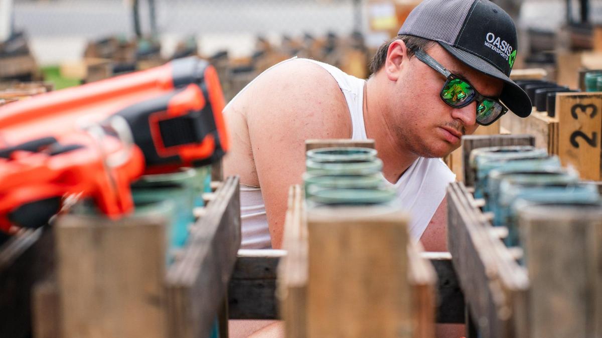 Nathen Massengill from Tennessee prepares the fireworks display at Truist Field on July 3, 2024. The 10th annual fireworks display at Truist Field will be about 22 minutes long and will contain 22,000 shells.
