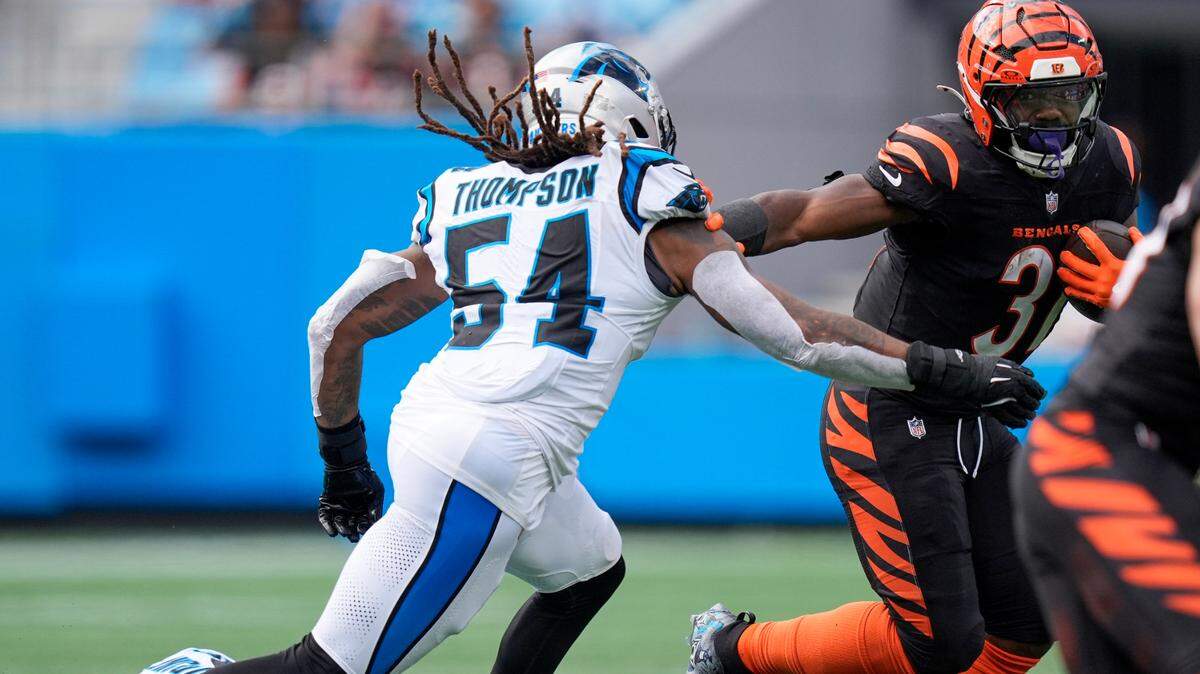 Cincinnati Bengals running back Zack Moss (31) tries to elude Carolina Panthers linebacker Shaq Thompson (54) during Sunday’s third quarter at Bank of America Stadium.