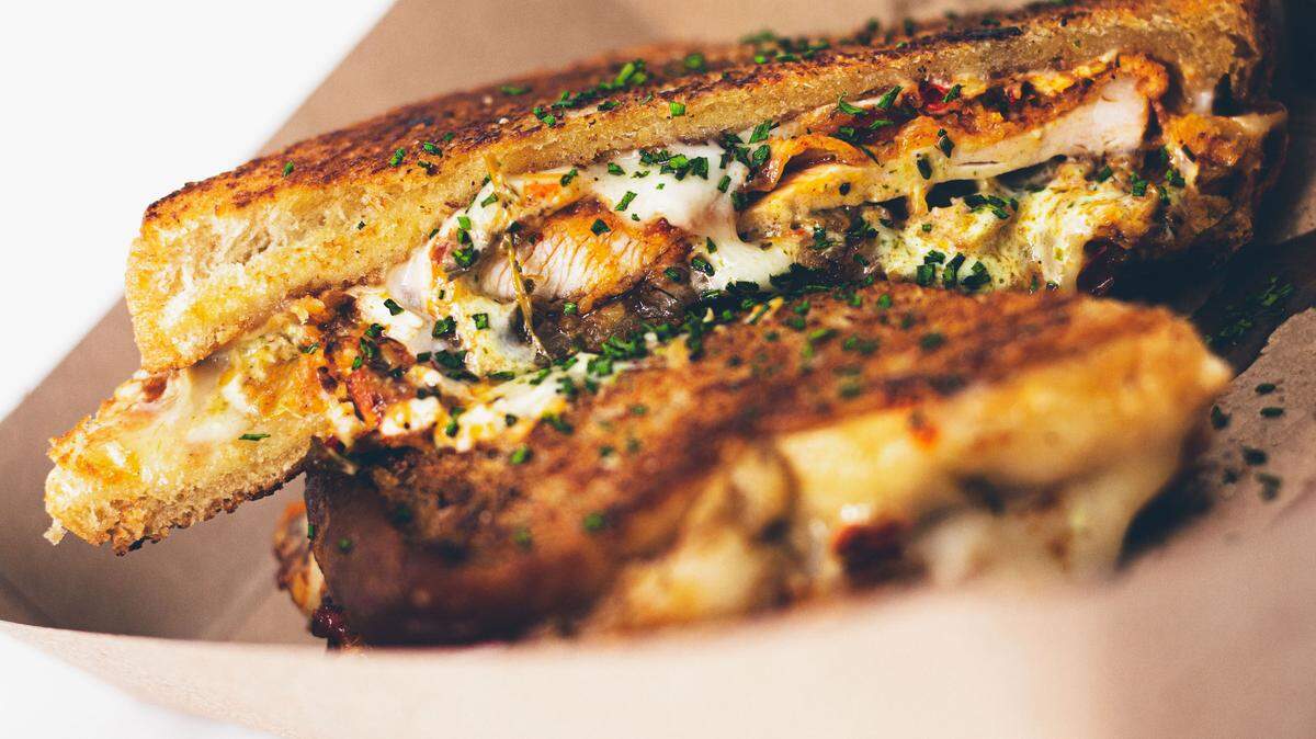 The Hot Chicken Smash at Another!? Food Truck is a grilled cheese-style chicken sandwich with house pickles, Green Monster house-made herb ranch and crispy onions.  The food truck will be at the upcoming “Soundbites: At The Track” event by Black Restaurant Weeks.