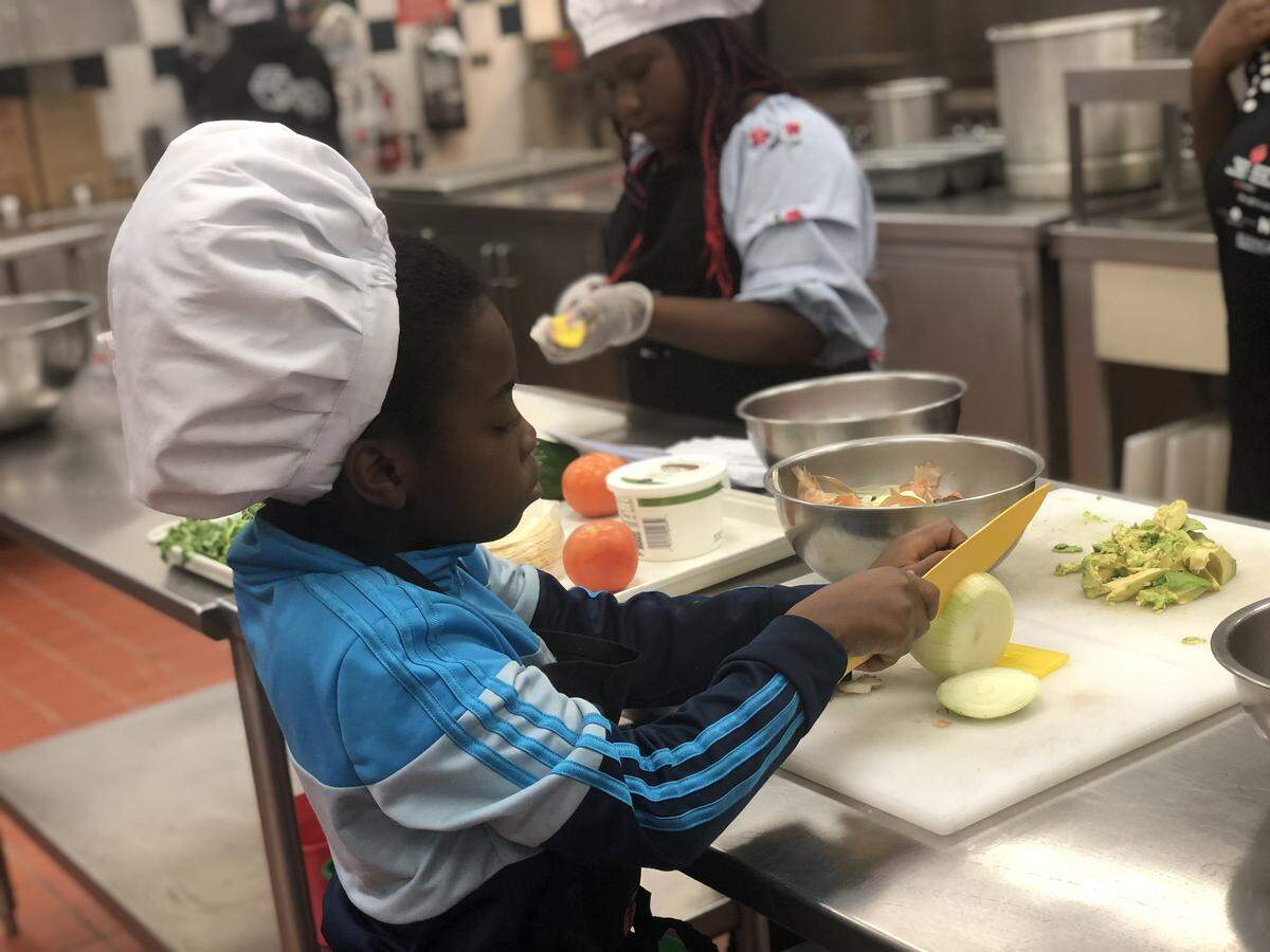 Druid Hill Academy students prepare vegetables during a cooking competition tied to a program of the Charlotte chapter of the American Heart Association.