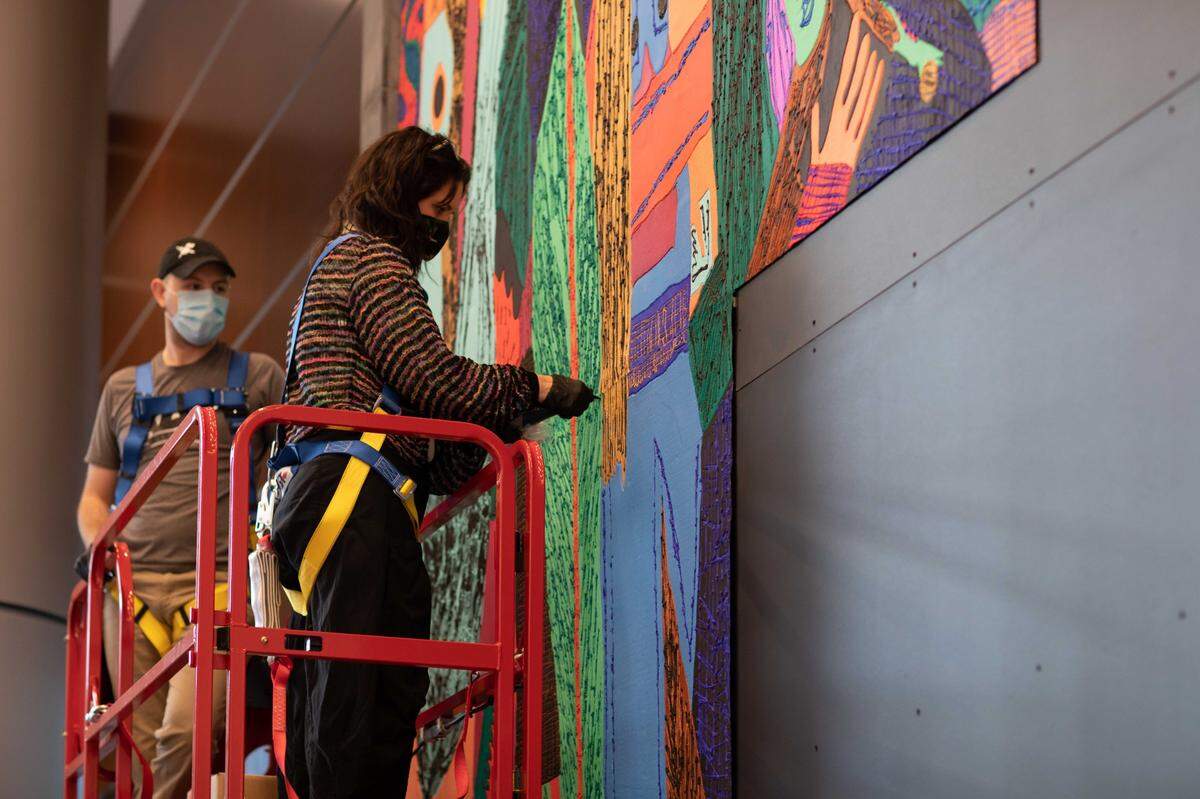 Artist Summer Wheat works on “Waterfalls.” The piece was installed in January at Lincoln Harris’ Legacy Union development in uptown. Equal parts painting, sculpture and textile, the artwork stands nearly 21 feet tall. It’s an ode to North Carolina’s history of makers and celebrates that state’s female creators.