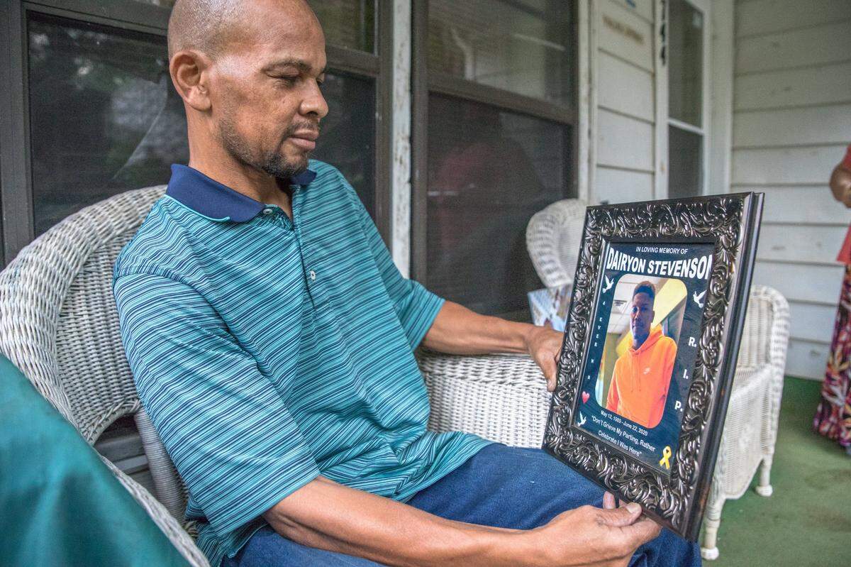 Kenneth Stevenson, father of Juneteenth shooting victim Dairyon Stevenson, holds an image of his son.