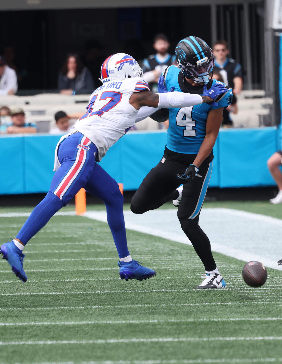 Carolina Panthers' Tetairoa McMillan glances back at the ball as Christian Benford tries to push him out of bounds during Sunday’s game at Bank of America Stadium.