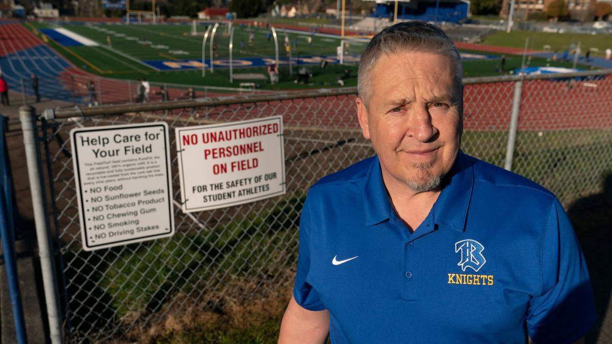 Joe Kennedy, a former assistant football coach at Bremerton High School in Washington state poses for a photo March 9, 2022 at the football field. Kennedy lost his coaching job after refusing to stop kneeling in prayer with players and spectators after games. On June 27, 2022 the U.S. Supreme Court ruled in his favor.
