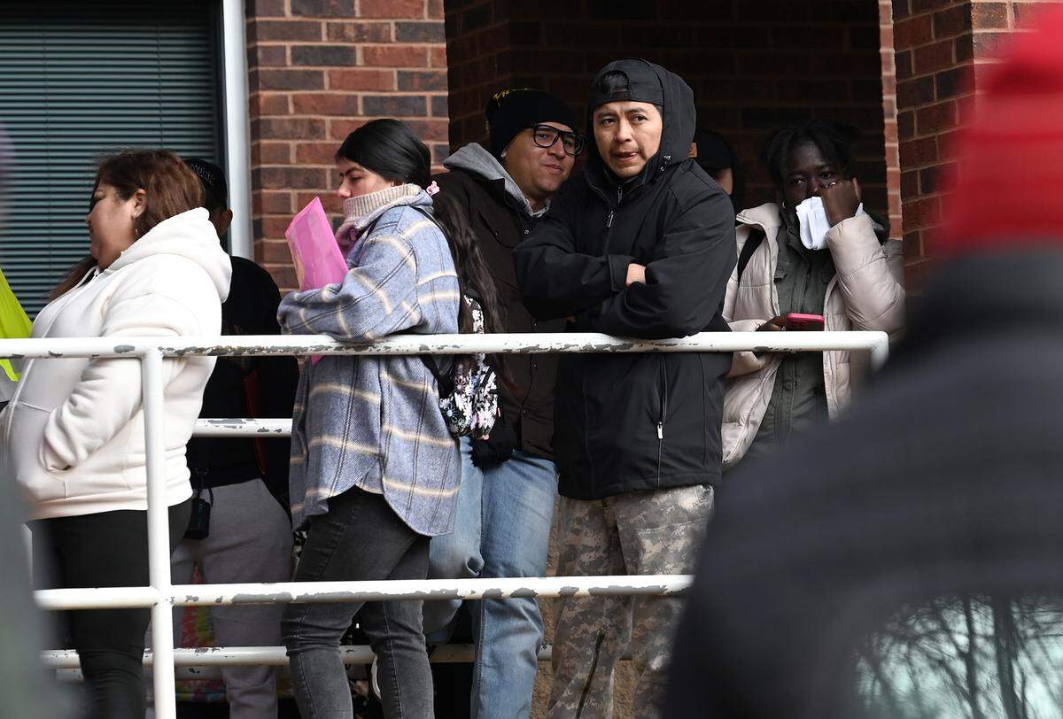 People wait outside the U.S. Department of Homeland Security office in Charlotte, NC on Thursday, January 16, 2025.