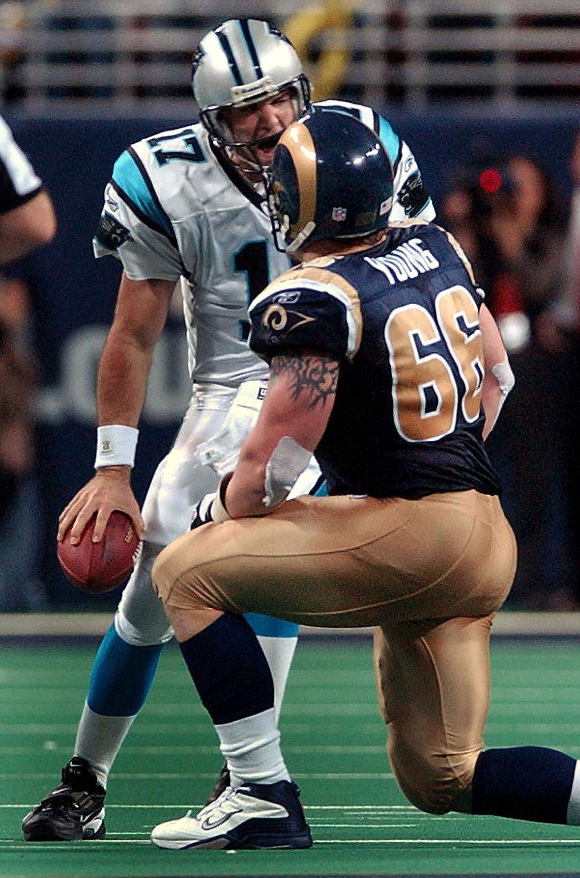 Jake Delhomme screams at St. Louis Rams defensive tackle Brian Young during the divisional playoff game on Jan. 10, 2004.