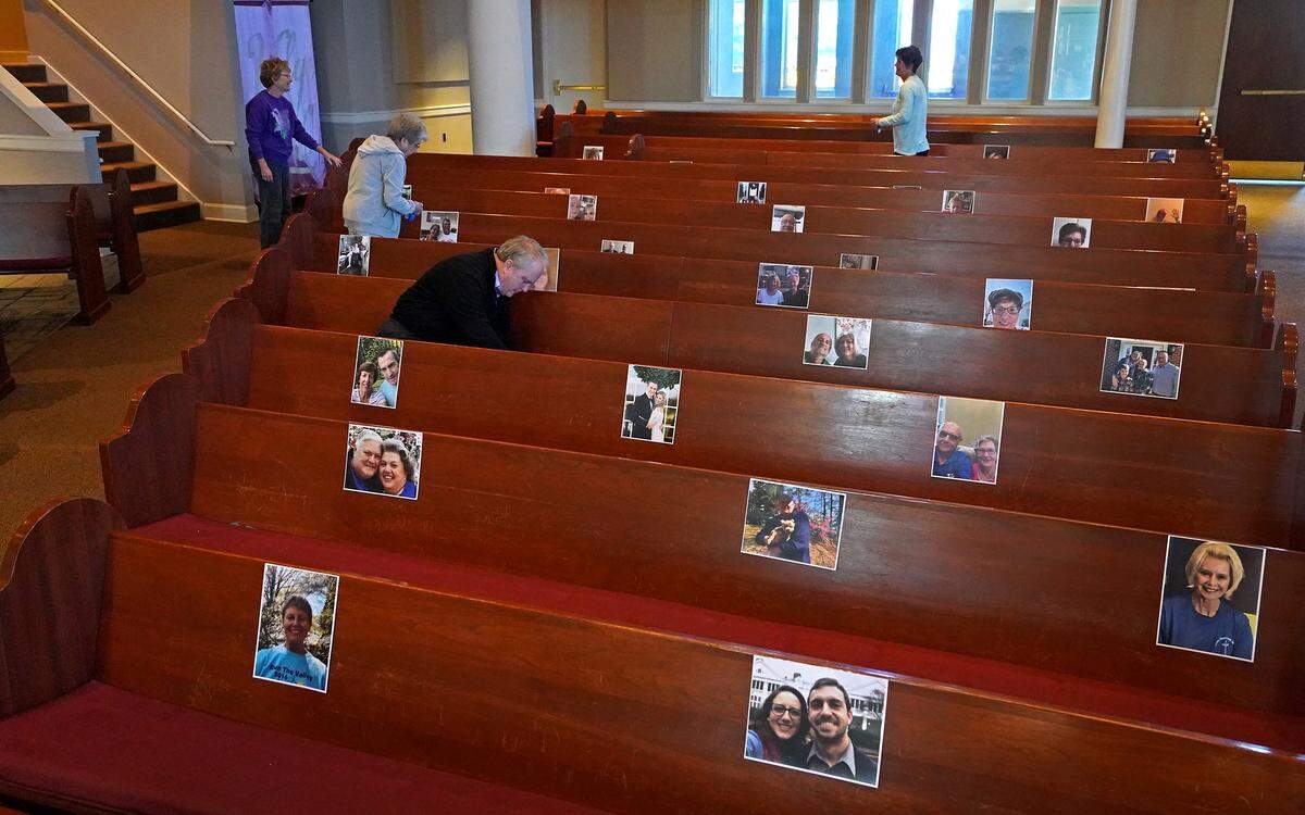 Matthews United Methodist Church places selfies of congregants on the pews of the sanctuary April 11 as the COVID-19 pandemic closed Charlotte churches. Under phase one of the North Carolina reopening plan that starts Friday, May 8, groups of 10 or more can gather for worship services only outdoors and must follow 6-foot social distancing.