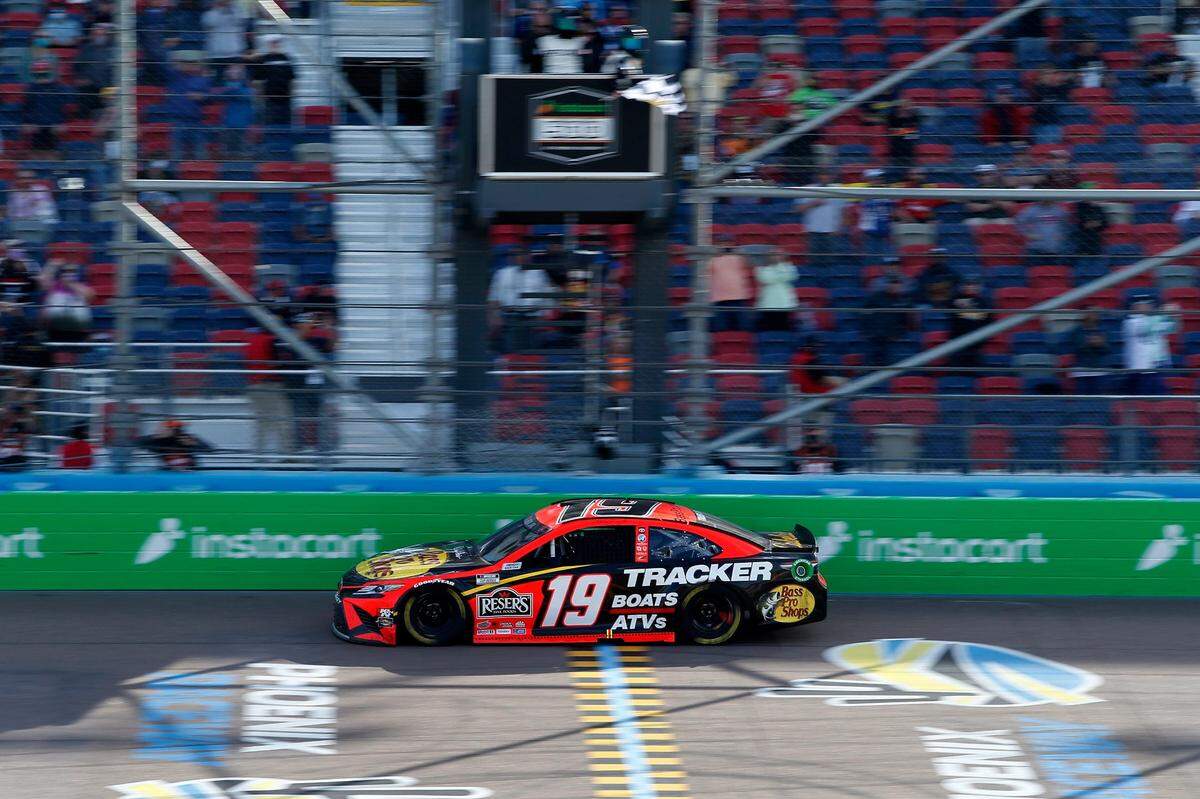 Martin Truex Jr. takes the checkered flag to win a NASCAR Cup Series auto race at Phoenix Raceway, Sunday, March 14, 2021, in Avondale, Ariz. (AP Photo/Ralph Freso)